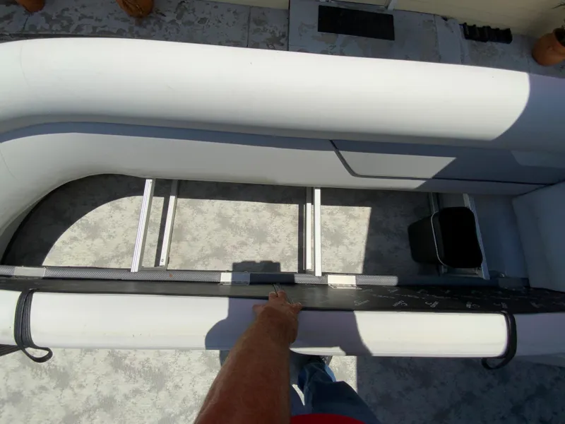 Slide: The Image of 2023 Crest Classic LX 220 SF boat interior with ladder and seating area. - 16