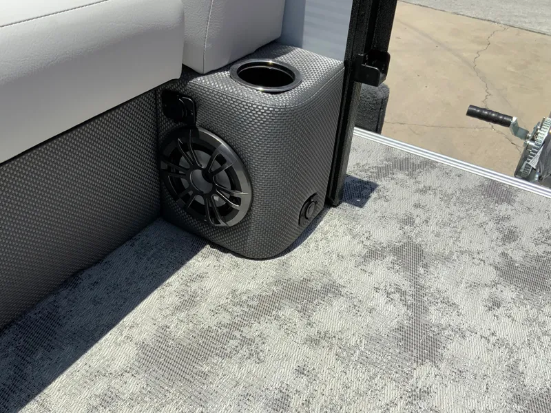 Slide: The Image of 2023 Crest Classic LX 220 SF boat interior with speaker and cup holder. - 17