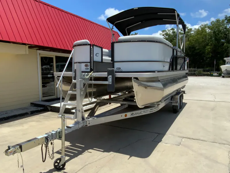Slide: The Image of 2023 Crest Classic LX 220 SF pontoon boat on trailer, parked outside. - 3