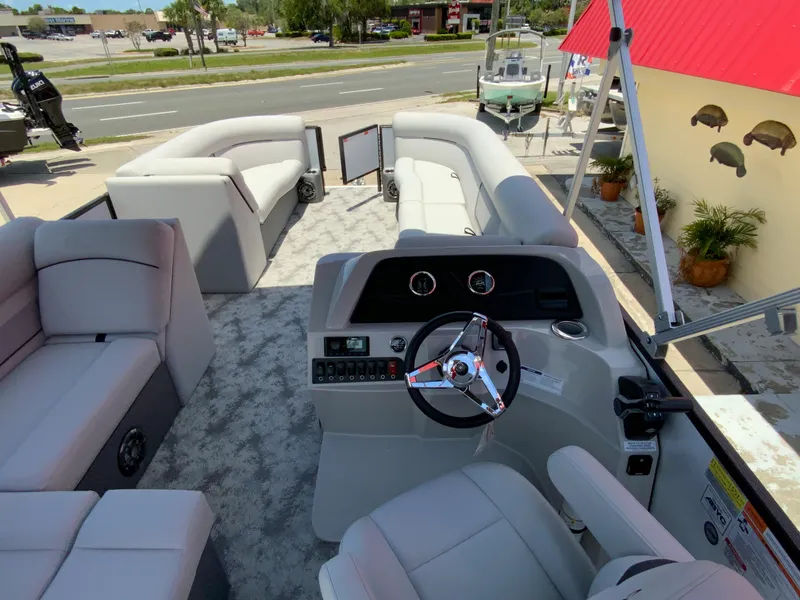 Slide: The Image of 2023 Crest Classic LX 220 SF pontoon boat interior with helm and seating. - 7