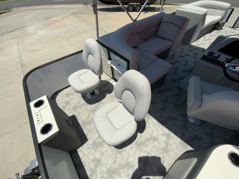 Slide: The Image of 2023 Crest Classic LX 220 SF boat interior with seating and cup holders. - 9