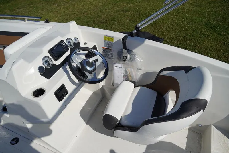 Slide: The Image of 2023 Starcraft SVX OB 171 OB boat cockpit with steering wheel and captain's chair. - 4