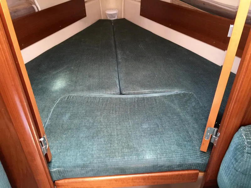 Slide: The Image of Cozy cabin interior of 2000 Beneteau Oceanis 321 sailboat with teal cushions. - 22