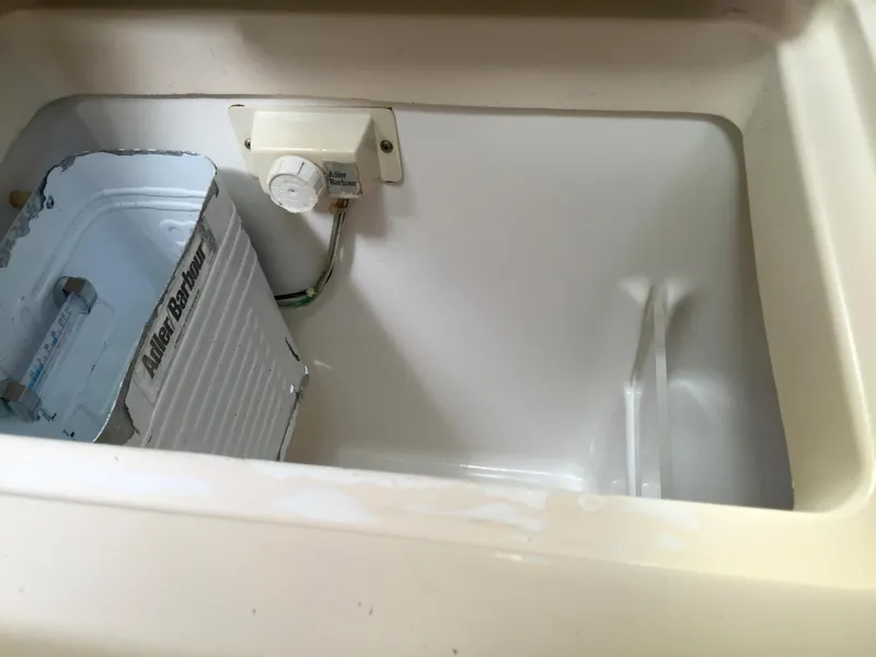 Slide: The Image of Interior of Beneteau Oceanis 321 (2000) showing a storage compartment with a can. - 28