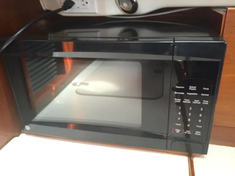 Slide: The Image of Microwave inside a 2000 Beneteau Oceanis 321 yacht kitchen area. - 29