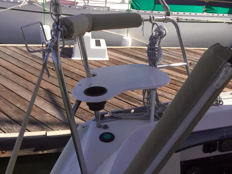 Slide: The Image of Beneteau Oceanis 321 sailboat cockpit detail, featuring a small table and railing, docked at a marina. - 38