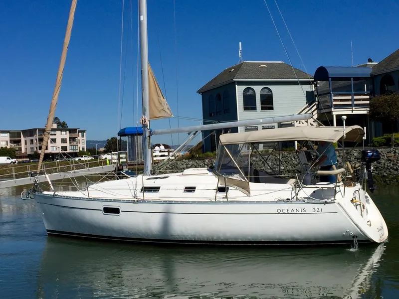 Slide: The Image of 2000 Beneteau Oceanis 321 sailboat docked near waterfront homes. - 41