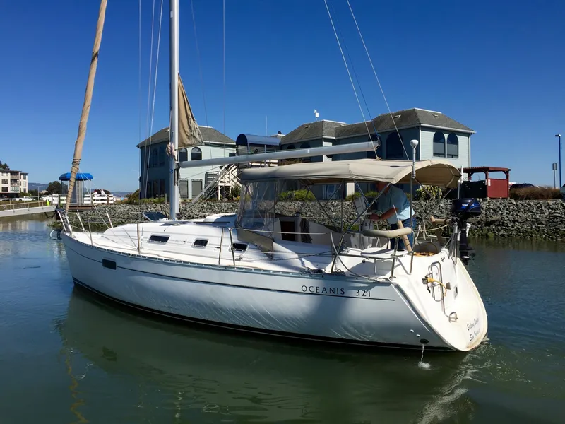 Slide: The Image of 2000 Beneteau Oceanis 321 sailboat docked near waterfront buildings. - 42