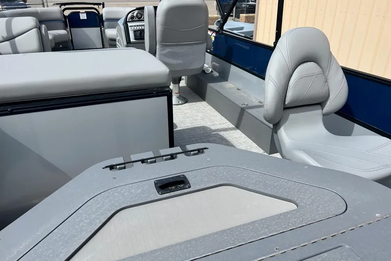 Slide: The Image of 2023 South Bay S224FCR pontoon boat interior with gray seating and modern dashboard. - 18