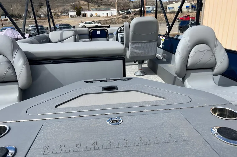 Slide: The Image of 2023 South Bay S224FCR pontoon boat interior with gray seating and fishing station. - 19