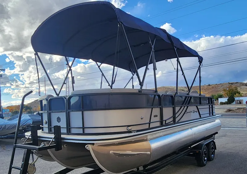 Slide: The Image of 2023 South Bay S224FCR pontoon boat with canopy on trailer. - 2