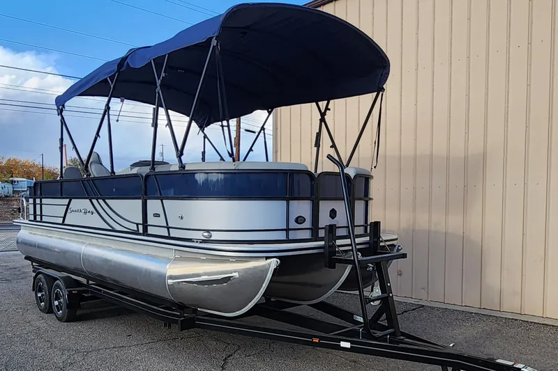 Slide: The Image of 2023 South Bay S224FCR pontoon boat on trailer with blue canopy. - 3