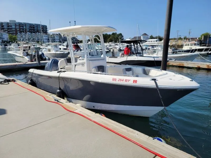 Slide: The Image of 2023 Robalo R230 boat docked at marina, clear day, waterfront view. - 0