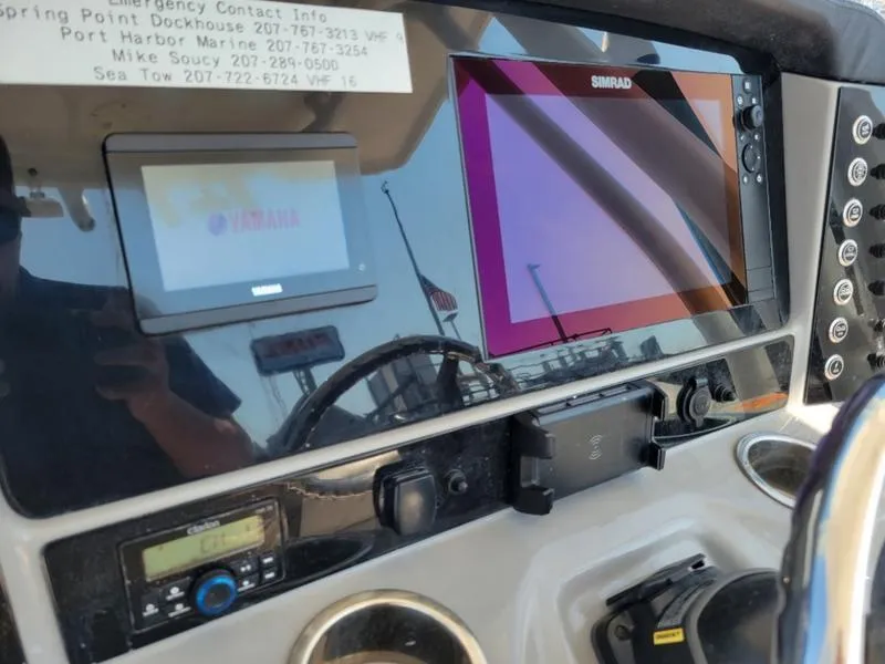 Slide: The Image of 2023 Robalo R230 boat dashboard with Simrad and Yamaha displays. - 10