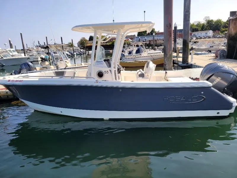 Slide: The Image of 2023 Robalo R230 boat docked in a marina. - 7