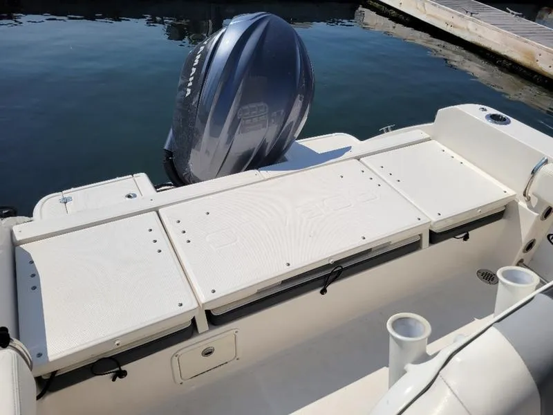 Slide: The Image of 2023 Robalo R230 boat stern with outboard motor at dock. - 9
