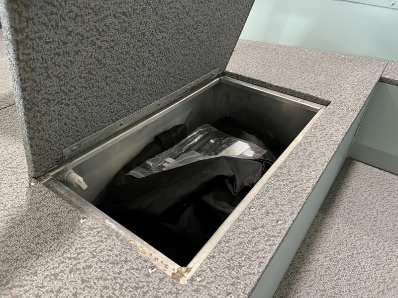 Slide: The Image of Open storage compartment in 2023 Starcraft Patriot 16 TL boat. - 10