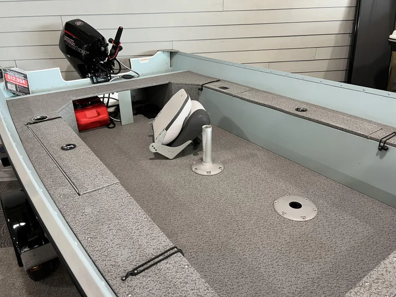 Slide: The Image of 2023 Starcraft Patriot 16 TL boat interior with motor and seating. - 2