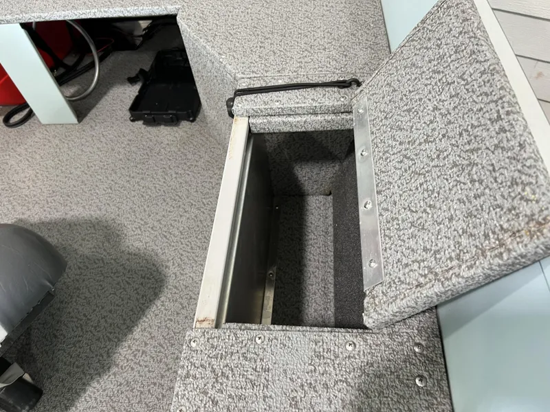 Slide: The Image of Open storage compartment in 2023 Starcraft Patriot 16 TL boat interior. - 3
