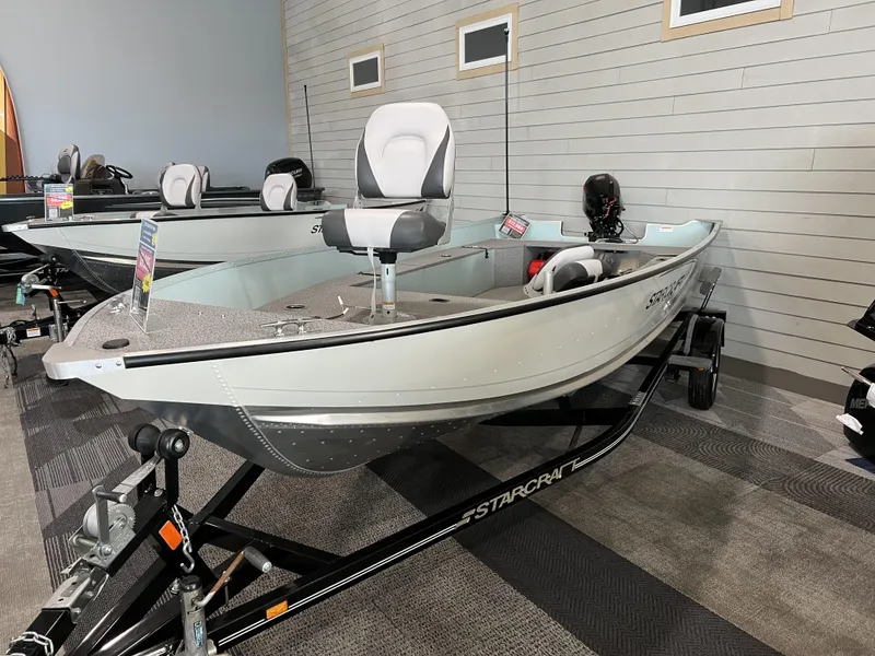 Slide: The Image of 2023 Starcraft Patriot 16 TL boat on display in showroom. - 8