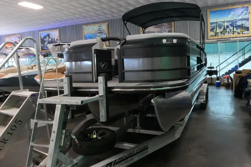 Slide: The Image of 2023 Vanderbilt 700T pontoon boat on display in a showroom. - 11