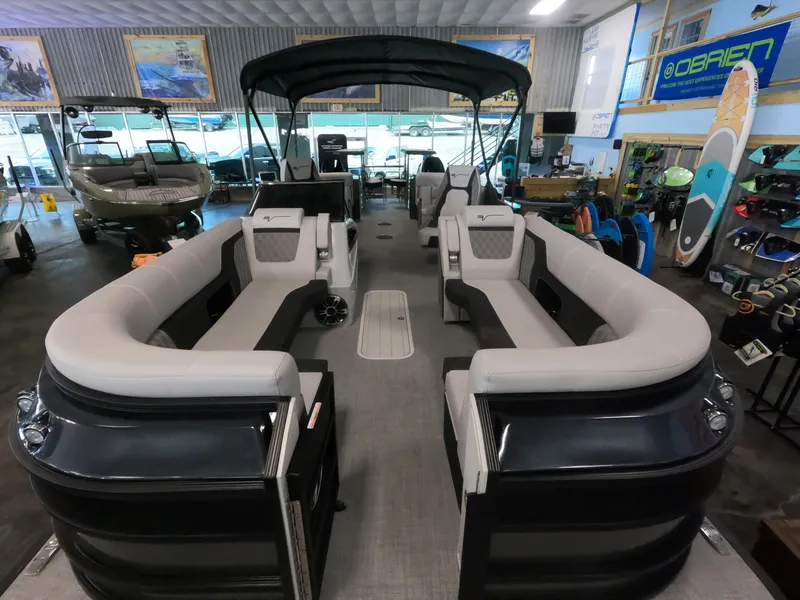 Slide: The Image of 2023 Vanderbilt 700T pontoon boat with spacious seating in a showroom. - 9