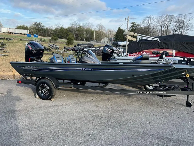 The Image of 2023 Ranger RT188C fishing boat on trailer, parked outdoors. - 1