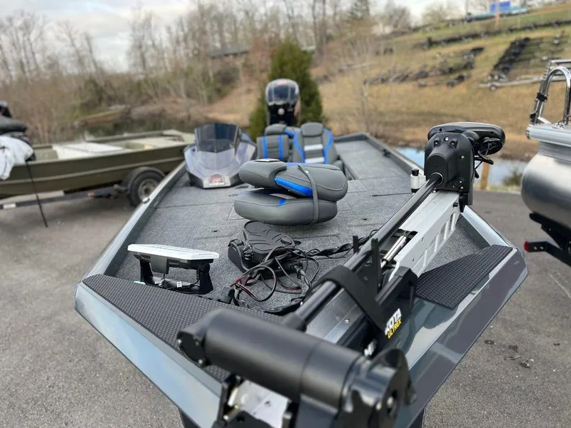 Slide: The Image of 2023 Ranger RT188C fishing boat with trolling motor and seating, parked outdoors. - 12