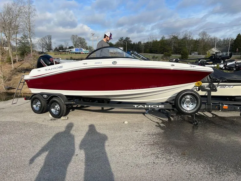 Slide: The Image of 2023 Tahoe Pontoon 200 S boat on a trailer, red and white exterior. - 3