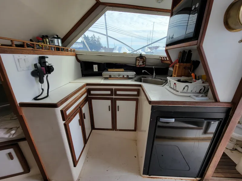 Slide: The Image of 1980 Blackfin 32 Flybridge boat kitchen with sink, cabinets, and appliances. - 12