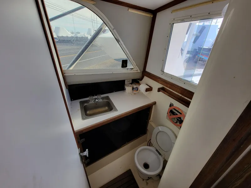 Slide: The Image of 1980 Blackfin 32 Flybridge boat bathroom with sink and toilet. - 13