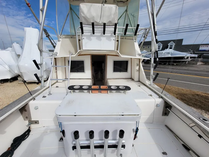 Slide: The Image of 1980 Blackfin 32 Flybridge boat deck with fishing rod holders and storage. - 15