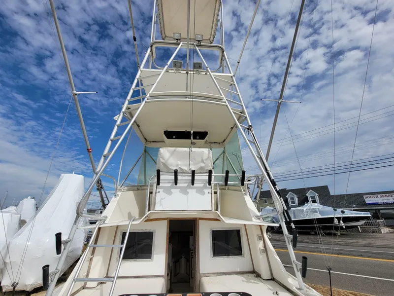Slide: The Image of 1980 Blackfin 32 Flybridge boat with dual decks and fishing rod holders. - 17