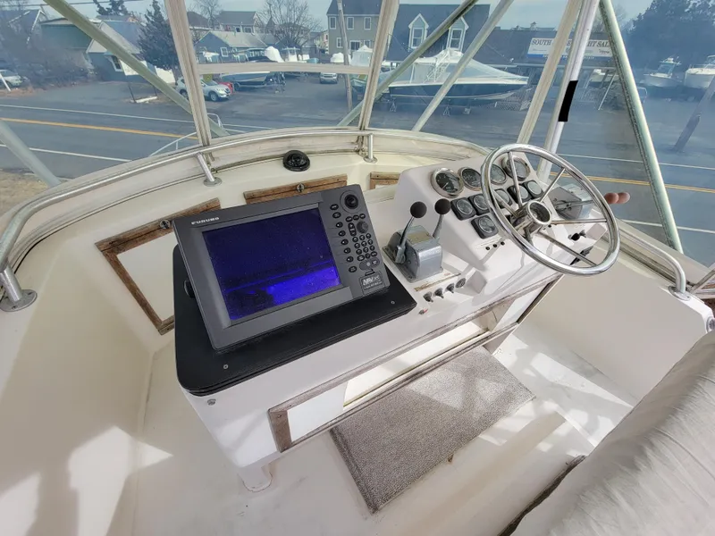 Slide: The Image of 1980 Blackfin 32 Flybridge helm with navigation equipment and steering wheel. - 18