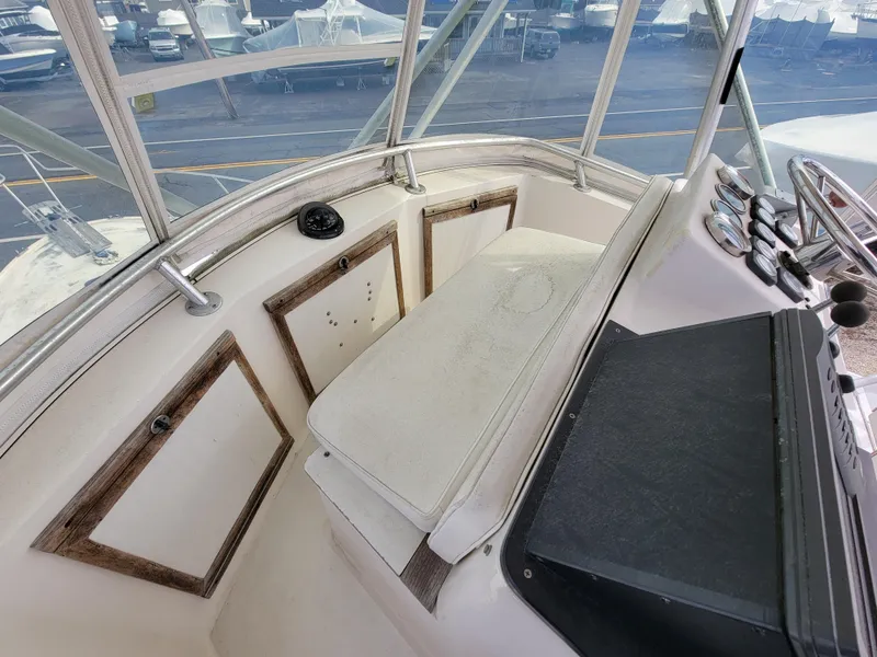 Slide: The Image of 1980 Blackfin 32 Flybridge helm station with seating and controls. - 19