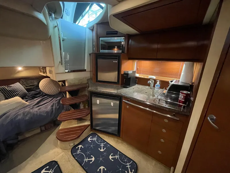 Slide: The Image of Interior of 2007 Sea Ray 38 Sundancer yacht with kitchen and sleeping area. - 15