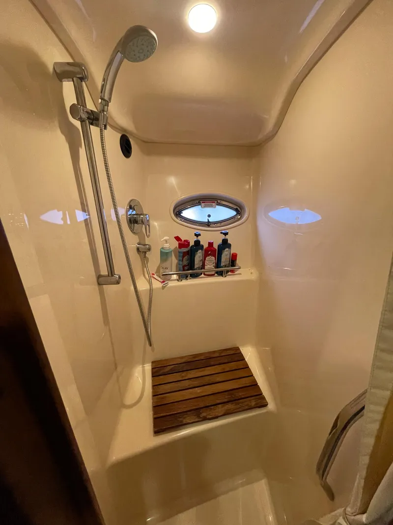 Slide: The Image of Shower area in 2007 Sea Ray 38 Sundancer yacht with wooden seat and porthole. - 17