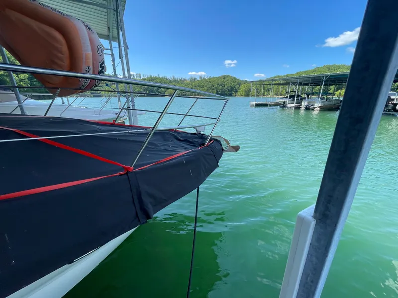 Slide: The Image of 2007 Sea Ray 38 Sundancer docked on a serene lake with clear skies. - 22