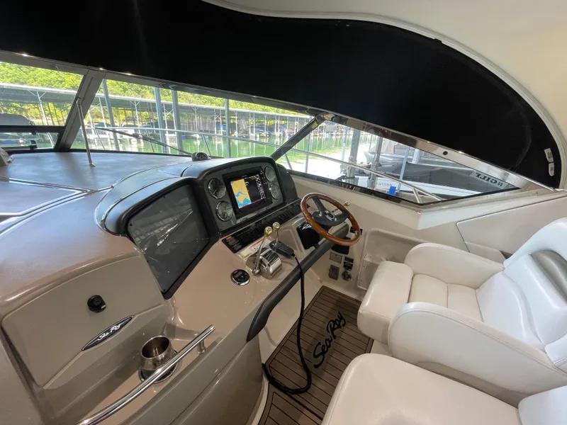 Slide: The Image of 2007 Sea Ray 38 Sundancer helm with modern controls and comfortable seating. - 4