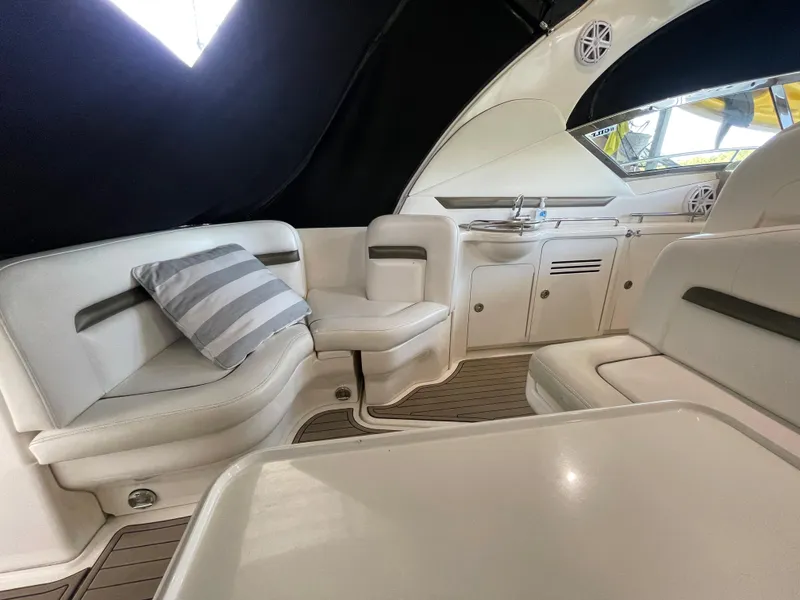 Slide: The Image of Interior of a 2007 Sea Ray 38 Sundancer yacht with white seating and striped pillow. - 9
