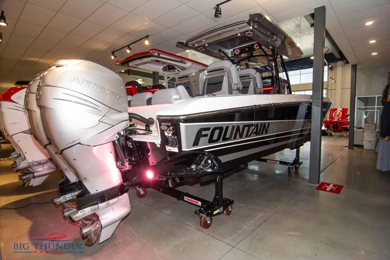 Slide: The Image of 2023 Fountain 34 SC boat in showroom with powerful Mercury outboard engines. - 12