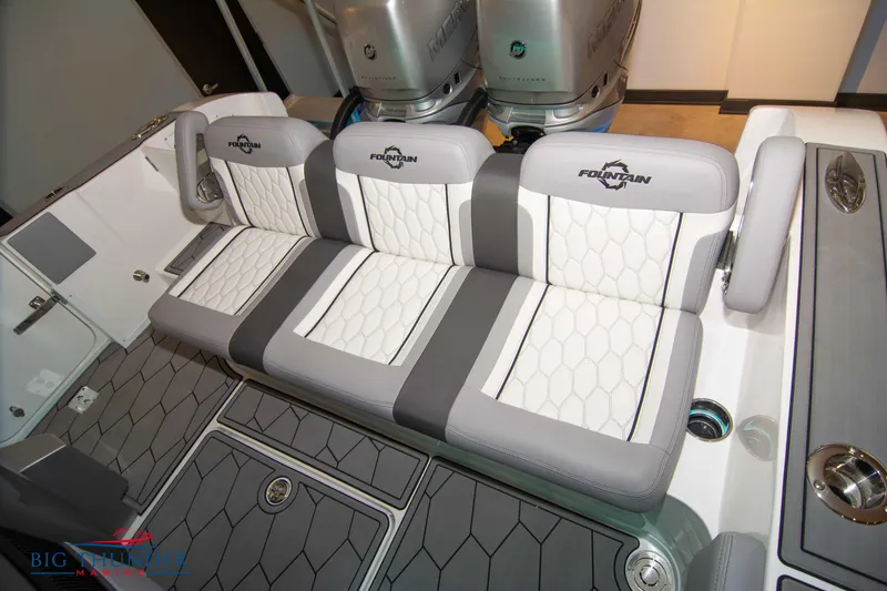 Slide: The Image of 2023 Fountain 34 SC boat with cushioned seating and dual outboard motors. - 26