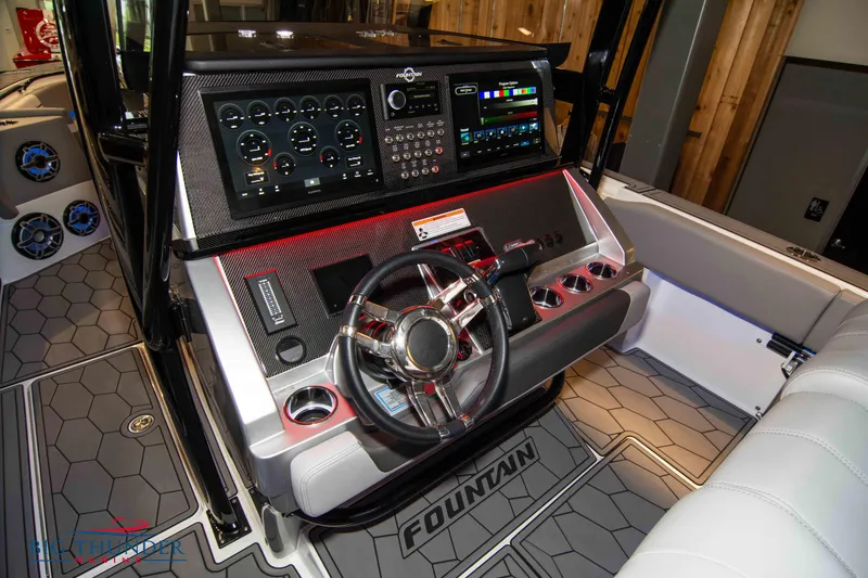 Slide: The Image of 2023 Fountain 34 SC boat dashboard with advanced controls and navigation system. - 42
