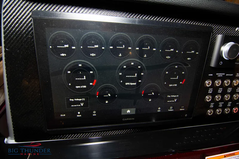 Slide: The Image of 2023 Fountain 34 SC boat dashboard with Garmin display and control panel. - 44