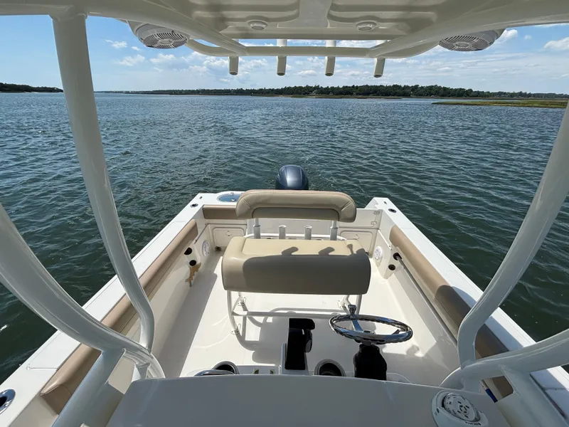 Slide: The Image of 2020 Sailfish 220 CC boat interior with helm, seating, and ocean view. - 15