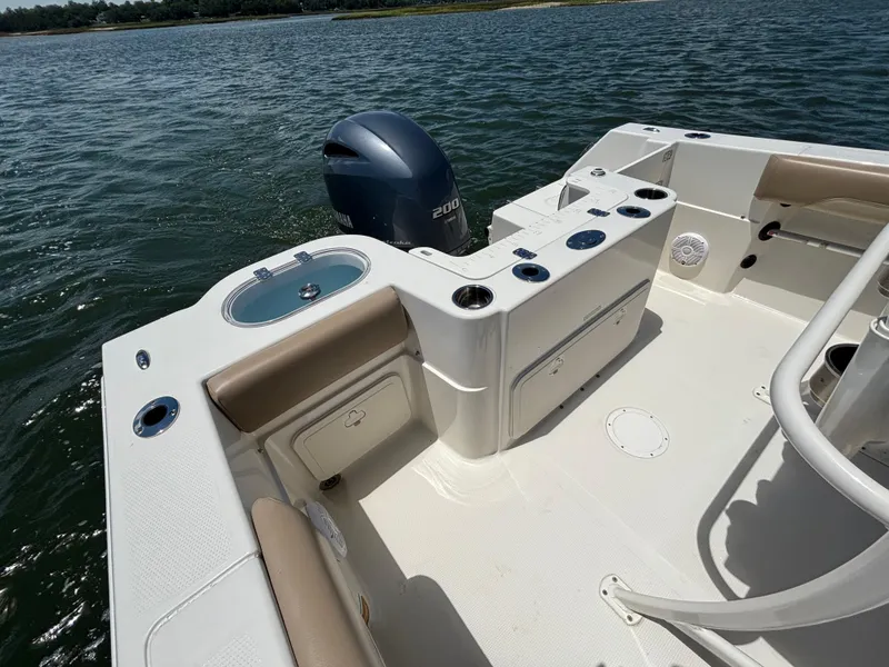Slide: The Image of 2020 Sailfish 220 CC boat interior with Yamaha engine on calm water. - 16