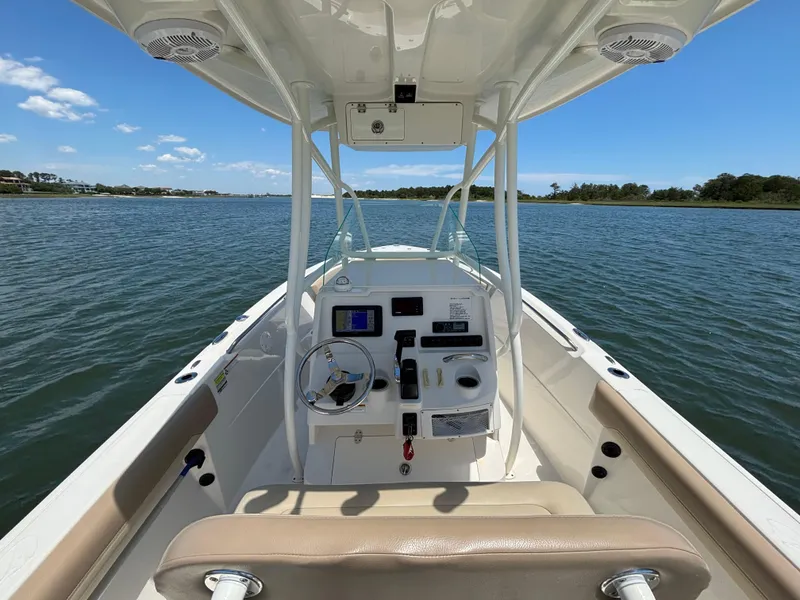 Slide: The Image of 2020 Sailfish 220 CC boat interior with steering console on calm water. - 18