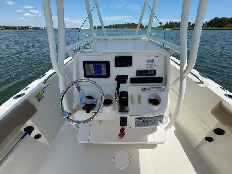 Slide: The Image of 2020 Sailfish 220 CC boat console with steering wheel and navigation system on open water. - 19