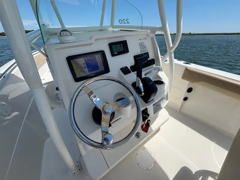 Slide: The Image of 2020 Sailfish 220 CC boat dashboard with steering wheel and navigation system. - 20