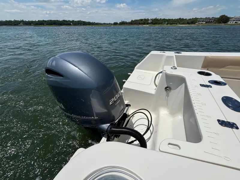 Slide: The Image of 2020 Sailfish 220 CC boat with outboard motor on calm water. - 25
